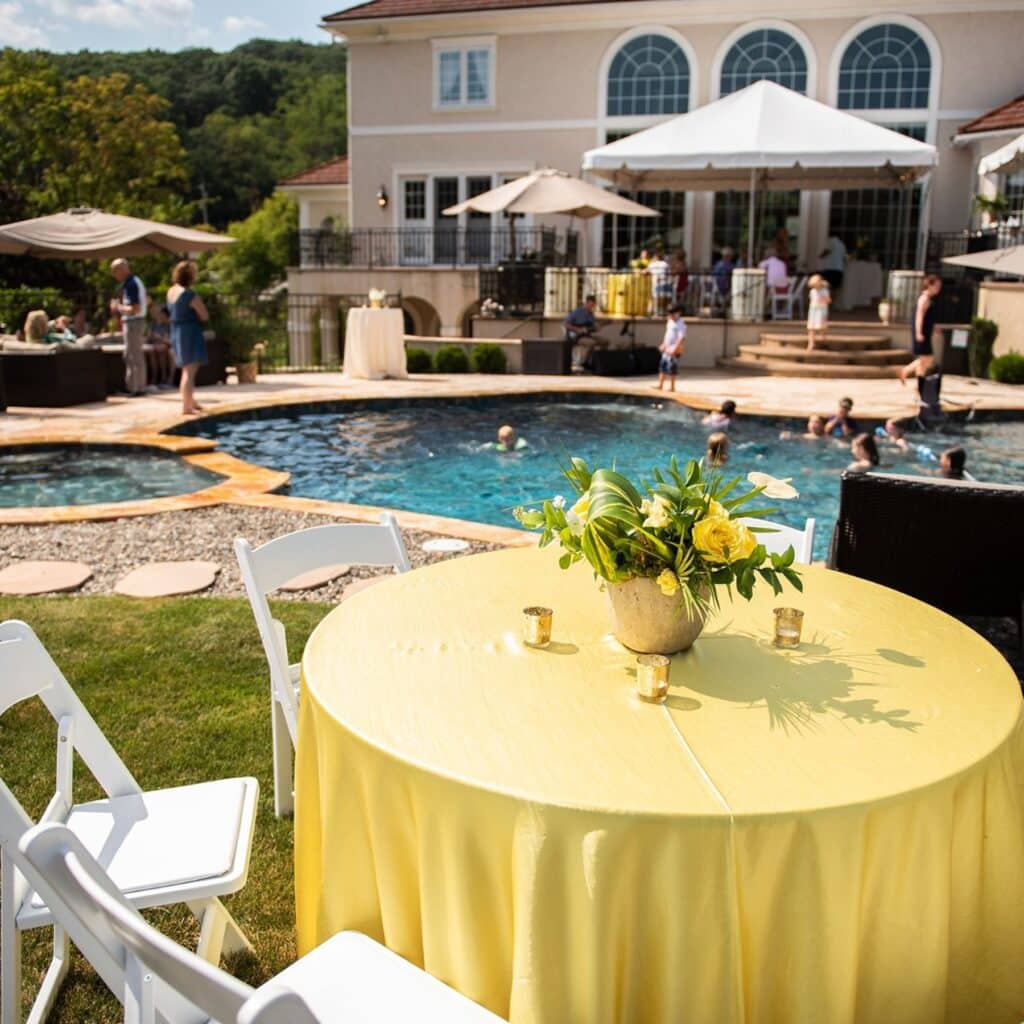 Backyard summer party with catering setup and guests enjoying a poolside event in Central PA